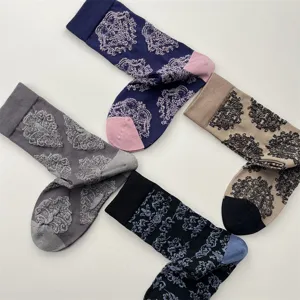 Detailed view of retro floral relief mid tube socks with vintage plant patterns for autumn winter.