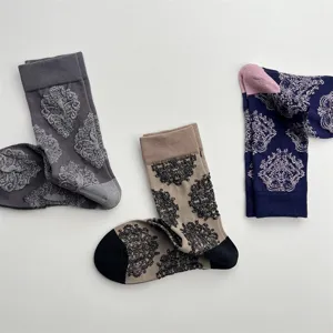 Detailed view of vintage embossed floral mid-calf socks, soft cotton retro design.