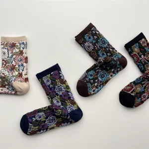 Detailed shot of retro floral mid-calf socks, embossed botanical pattern design, cotton fabric.