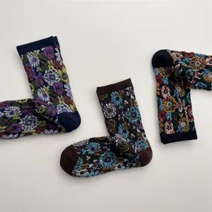 Detailed view of retro floral relief cotton mid-tube socks, vintage botanical knit pattern.