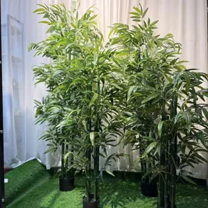 Artificial bamboo plant detail view, realistic green foliage in black pot for home decor.