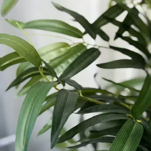 Artificial bamboo leaves detail close up, realistic green foliage for indoor outdoor decor.