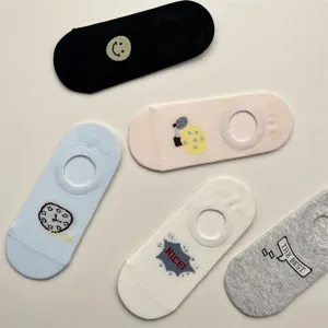 Detailed view of breathable mesh invisible boat socks with cute cartoon prints and smiling faces.