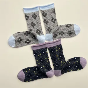 Detailed view of vintage embossed floral women socks with contrast rolled cuffs and soft texture.