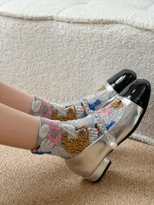 Detailed view of vintage style floral leopard print crew socks, soft cotton material.