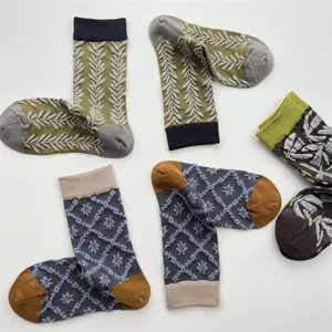 Japanese vintage style crew socks detail with textured wheat, floral patterns, and bird embroidery.