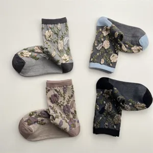 Details of retro floral embroidered mid-calf socks, showing vintage textured relief flowers.