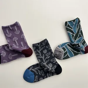 Detailed view of vintage relief floral and geometric pattern cotton crew socks for women.