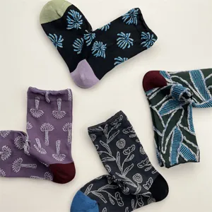 Women vintage cotton mid-tube socks with irregular geometric and botanical floral relief patterns.