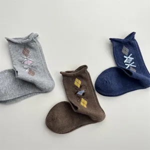 Detail view of Korean retro style mid-calf socks featuring argyle patterns and cute bows.