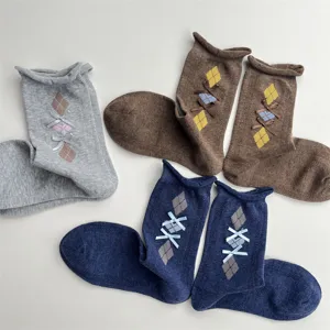 Detailed view of Korean vintage argyle knit mid-calf socks with sweet bow knots, cozy cotton.