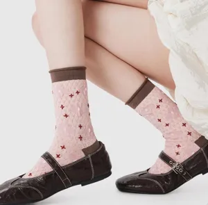 Close-up detail view of Japanese vintage embossed floral crew socks with contrast rolled cuffs.