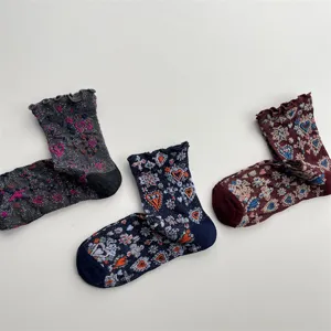 Close-up detail of vintage style floral jacquard ruffles mid-calf socks with metallic threads.