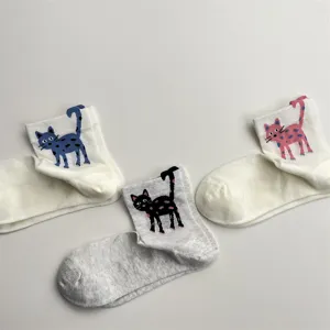 Close-up detail shot of cute cat patterned breathable mesh short socks, soft cotton fabric.