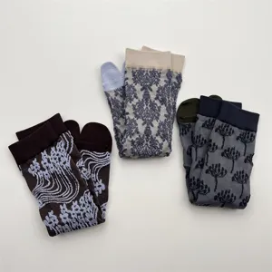 Detail shot of vintage floral embossed split toe socks featuring unique knit patterns and colors.