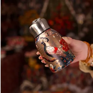 Detailed view of mini thermos cup with intricate peacock flower print, stylish portable design.