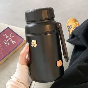 Stainless steel vacuum insulated water bottle detail showing matte black finish and cute bear.