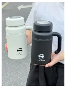 Detailed view of portable stainless steel thermos cups in black and white with handle.