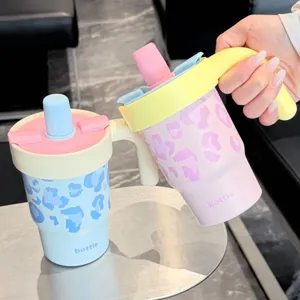 Cute leopard print stainless steel thermos cup with handle and straw lid for portable use.
