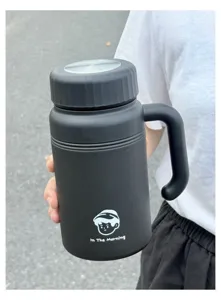 Detail view of black stainless steel insulated thermos mug with handle for office use.