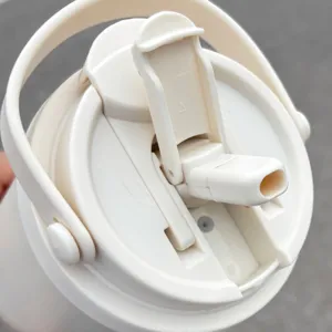 Detailed view of the insulated tumbler lid with portable handle and straw design.