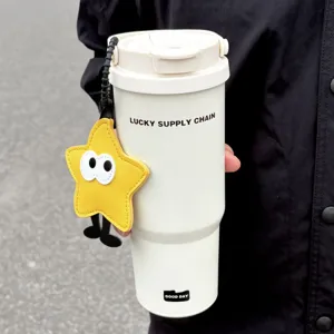 Stainless steel insulated tumbler with cute cartoon star pendant for outdoor travel.