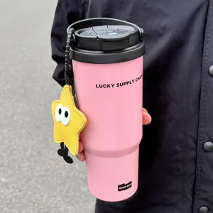 Detailed view of the large pink insulated tumbler with a cute star charm and handle, outdoor use.