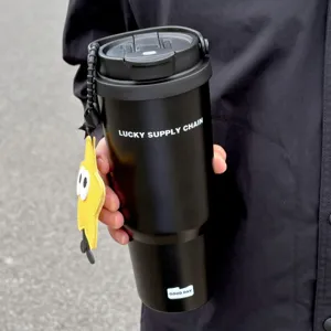 Detailed close-up shot of black stainless steel insulated tumbler with handle and star pendant
