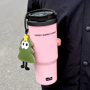 Pink stainless steel insulated tumbler with handle and cute Christmas tree charm.