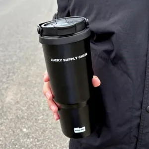 Detail shot of black stainless steel insulated tumbler with portable handle for outdoor travel.