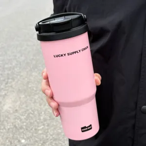 Detail view of the stainless steel insulated tumbler with handle and pink finish.
