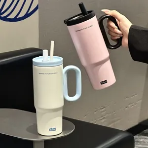 Large capacity stainless steel insulated tumbler with handle and straw for daily use.