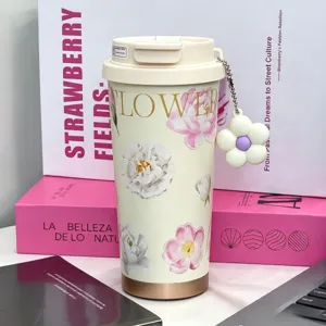 Detailed shot of the aesthetic floral stainless steel travel coffee mug with cute flower charm.