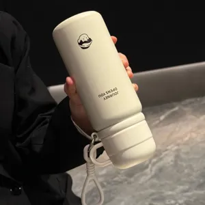 Stainless steel insulated water bottle double drink vacuum flask with portable silicone handle beige