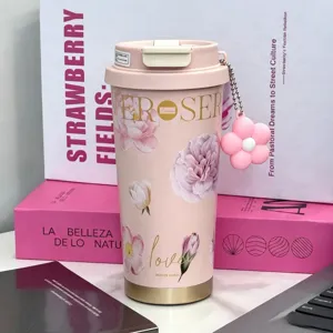 Pink floral insulated travel coffee mug with cute flower pendant, stylish stainless steel cup.