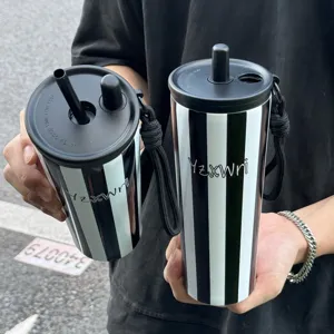 Stainless steel vacuum tumbler with straw and strap, large capacity portable travel water cup.