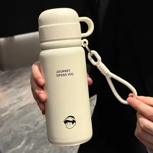 Close-up detail shot of the beige stainless steel insulated water bottle with carry strap.