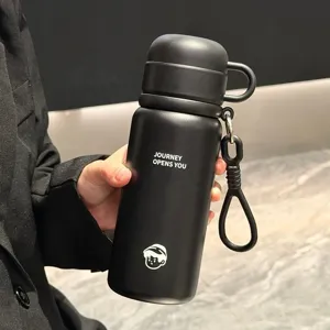 Detail shot of black stainless steel vacuum insulated water bottle with portable strap and handle.