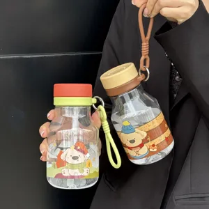 Detailed view of cute cartoon straw water bottle with portable strap for kids and students.