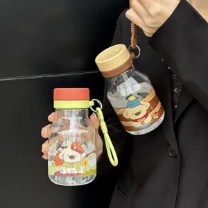 Detailed close-up shot of portable cute cartoon straw water bottle with handy strap.