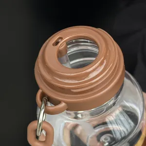 Detail view of portable kids straw water cup with brown cap and clear body for daily use.