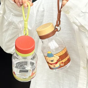 Cute portable plastic straw water bottle with cartoon puppy print and silicone strap for kids.