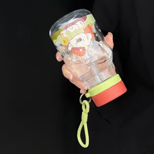 Transparent cartoon straw water bottle detail, cute bear print and portable student cup design.