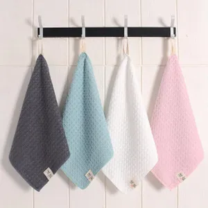 Hanging hand towel set with waffle texture in four colors, detail shot of neat wall hook display.