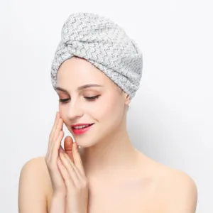 Detail view of the soft grey microfiber hair drying towel cap, showing absorbent fabric texture.
