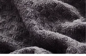 Close-up detail of dark grey waffle textured fabric showing soft and absorbent surface.