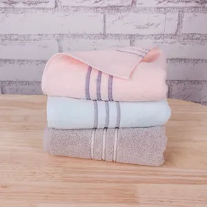 Cotton stripe thickened absorbent face towel set neatly stacked on table main view