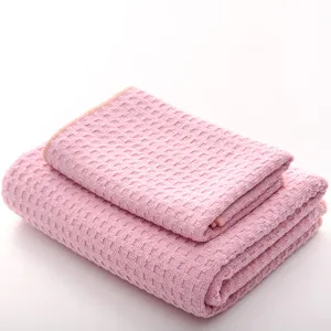 Pink waffle weave bath towel and face towel set, soft, absorbent, and quick-drying.