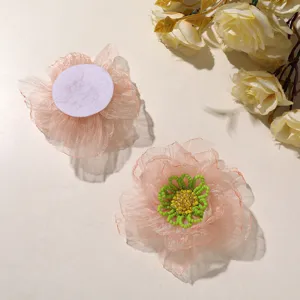 Detailed view of peach organza beaded flower patch with vibrant green and yellow bead centers.
