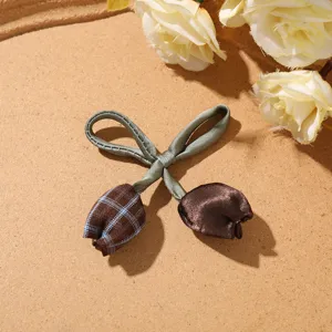 Sweet forest style dual tulip bow hair accessory detail shot, cute fabric DIY charm.